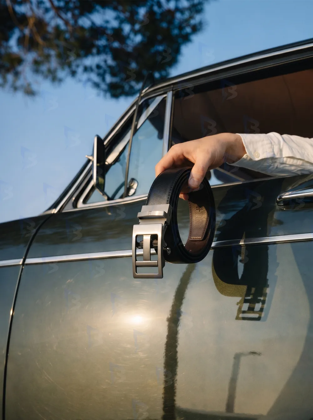 Belt hanging from a vintage car door