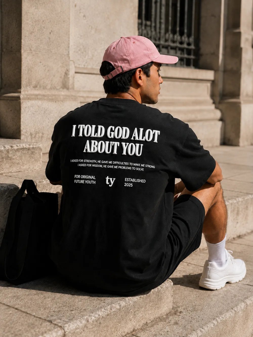 I Told God tee back print, seated on stone steps